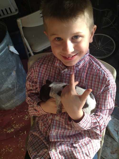 Conrad (almost 9 years old) holds a pup