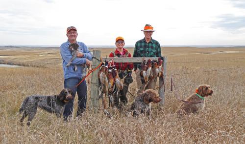 TracHer, Tom holding Max the GWP pup, Susan, Max the griff, Jim, and Zepher.